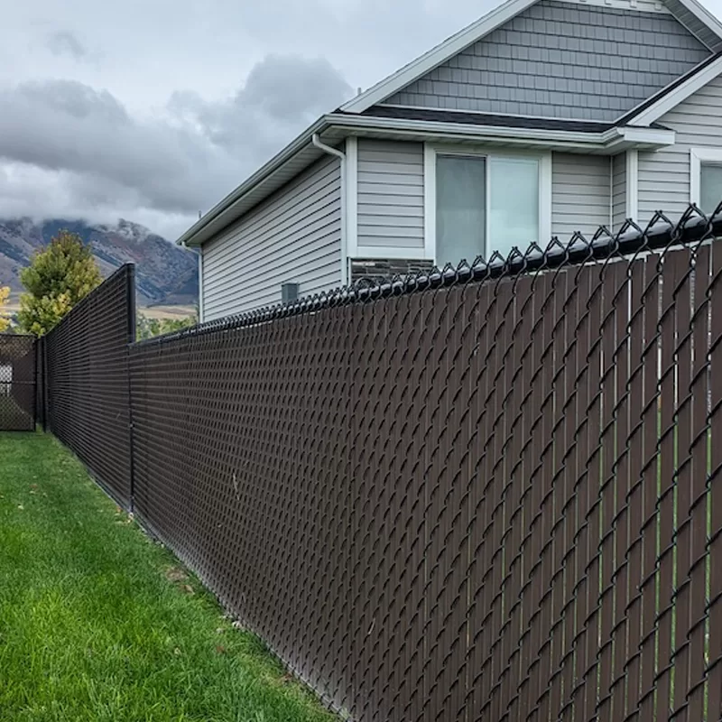 High & Tight Fencing installed a chain link fence with brown privacy slats in Logan, Utah 