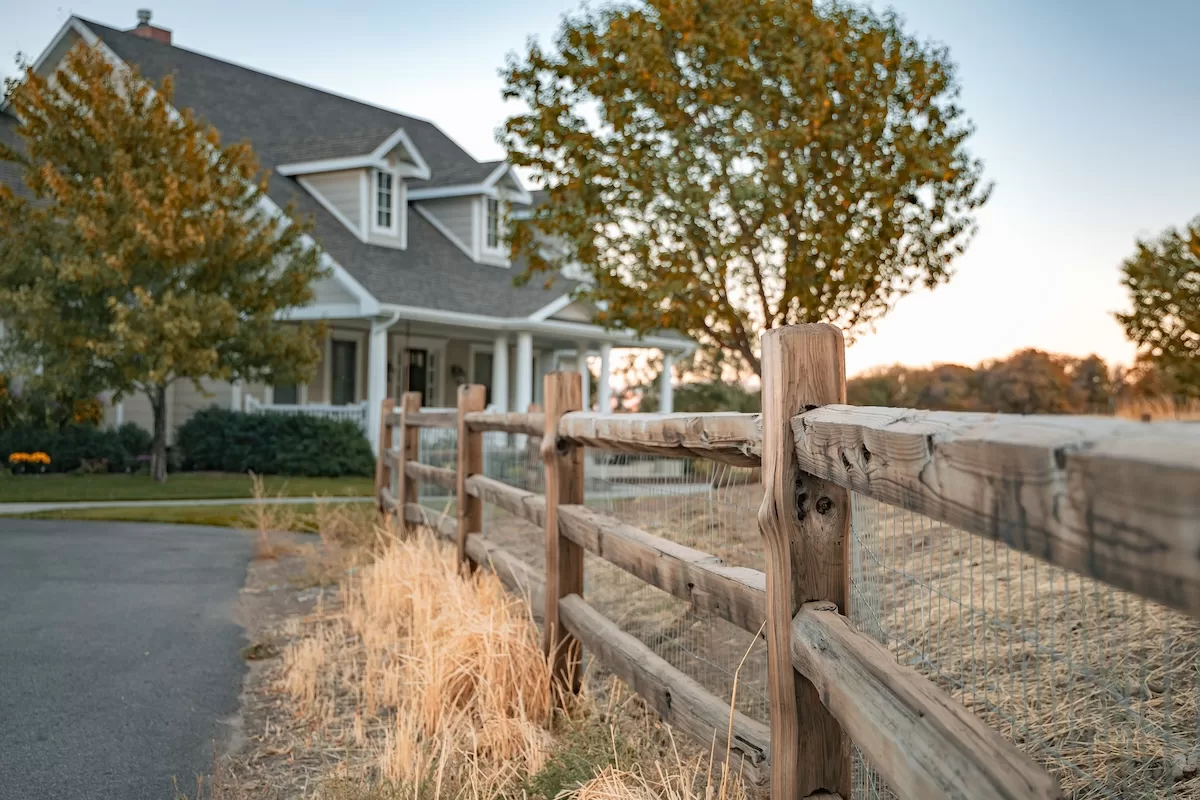 High-Tight-Fencing-T.Fletcher-wellsville-utah-split-cedar-fence High & Tight Fencing split cedar fence in Wellsville Utah next to a farmhouse